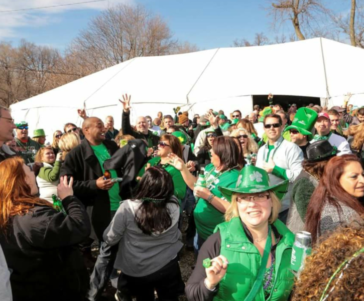A St. Patricks Day Celebration event with a large gathering of individuals.