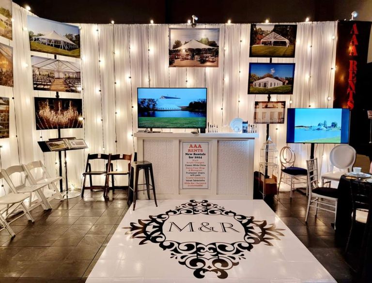 A decorated and well lit up display booth showcasing AAA Rents past events.