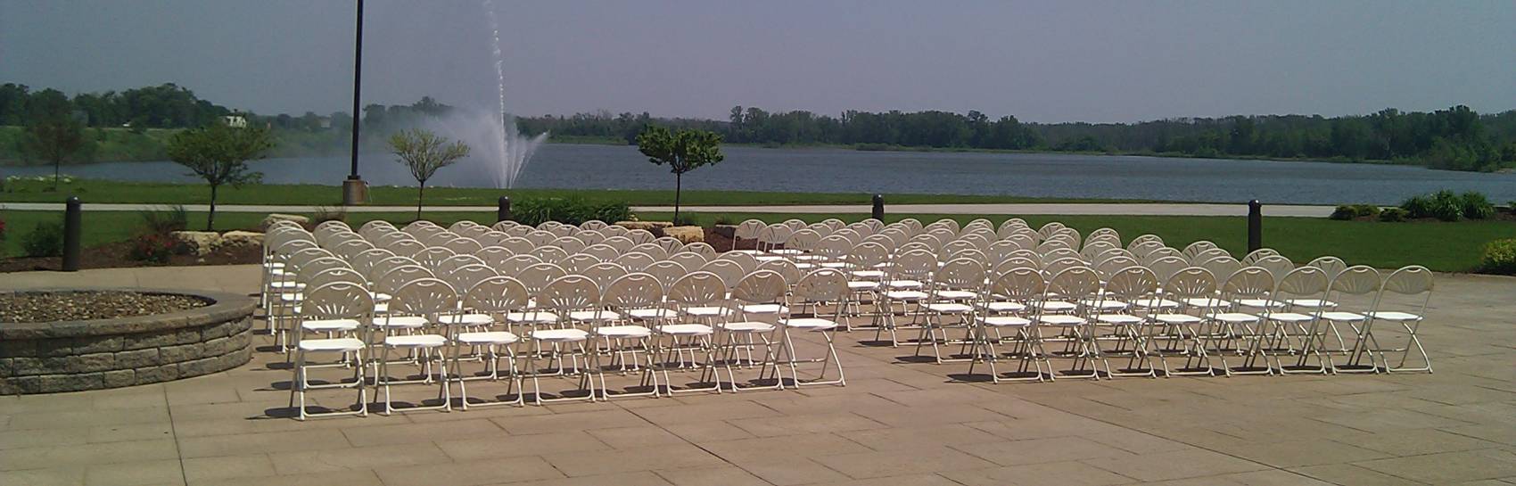 An arrangement of folding chairs facing a fountain.