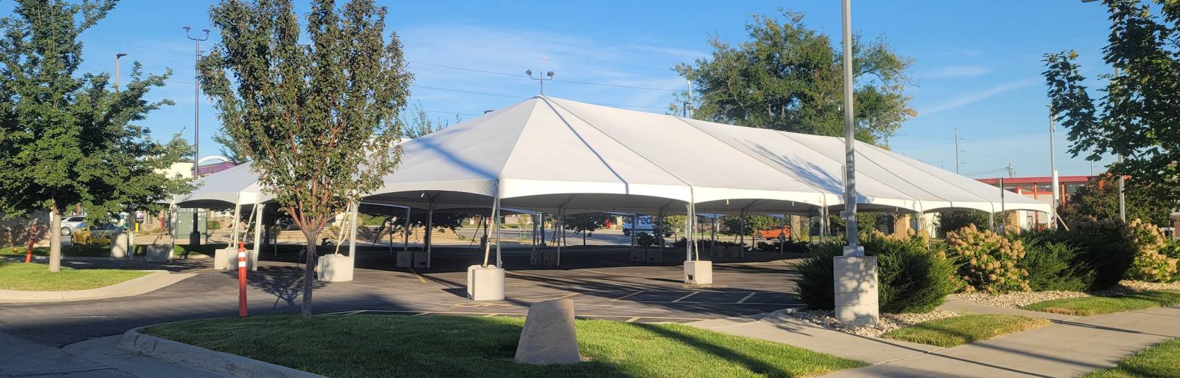 An outdoor image of a tent being set up for a festival.