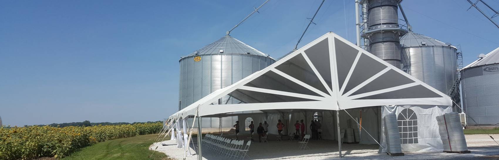 A tent with clear sunburst ends on a farm