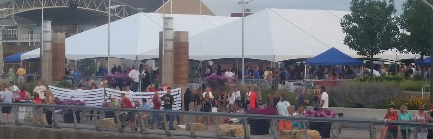 An outdoor event with a large gathering of individuals celebrating!