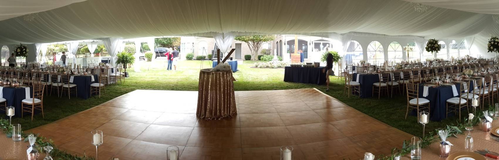 An indoor tent view with natural lighting flooding in to showcase the beautifully arranged set up.
